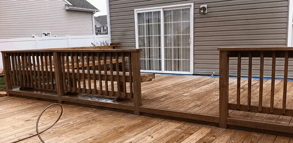 Deck sealing service protecting a backyard wood deck and railings in Atlanta, GA