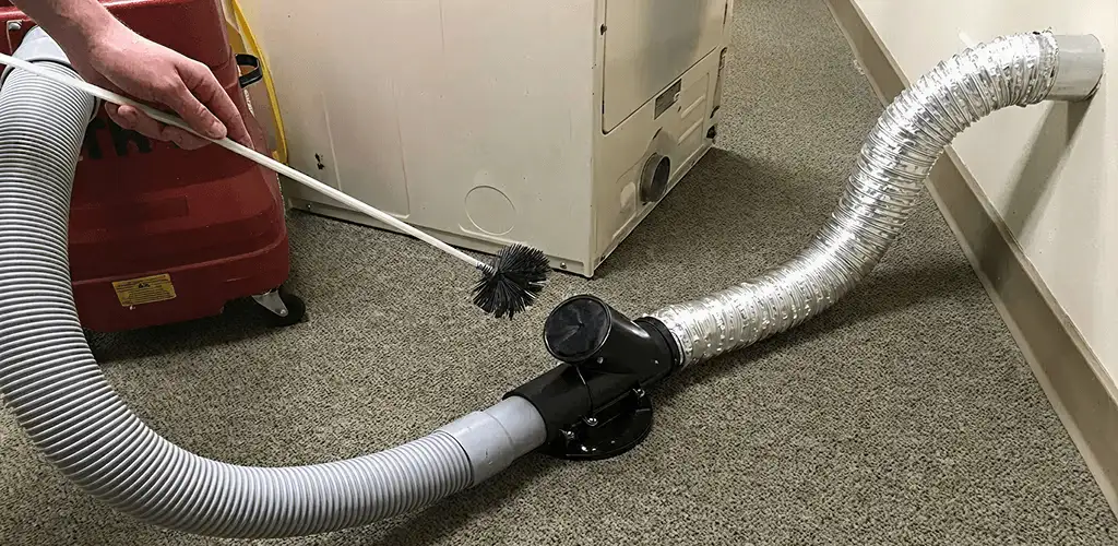 Dryer vent cleaning service removing lint from a dryer duct connection in Atlanta, GA
