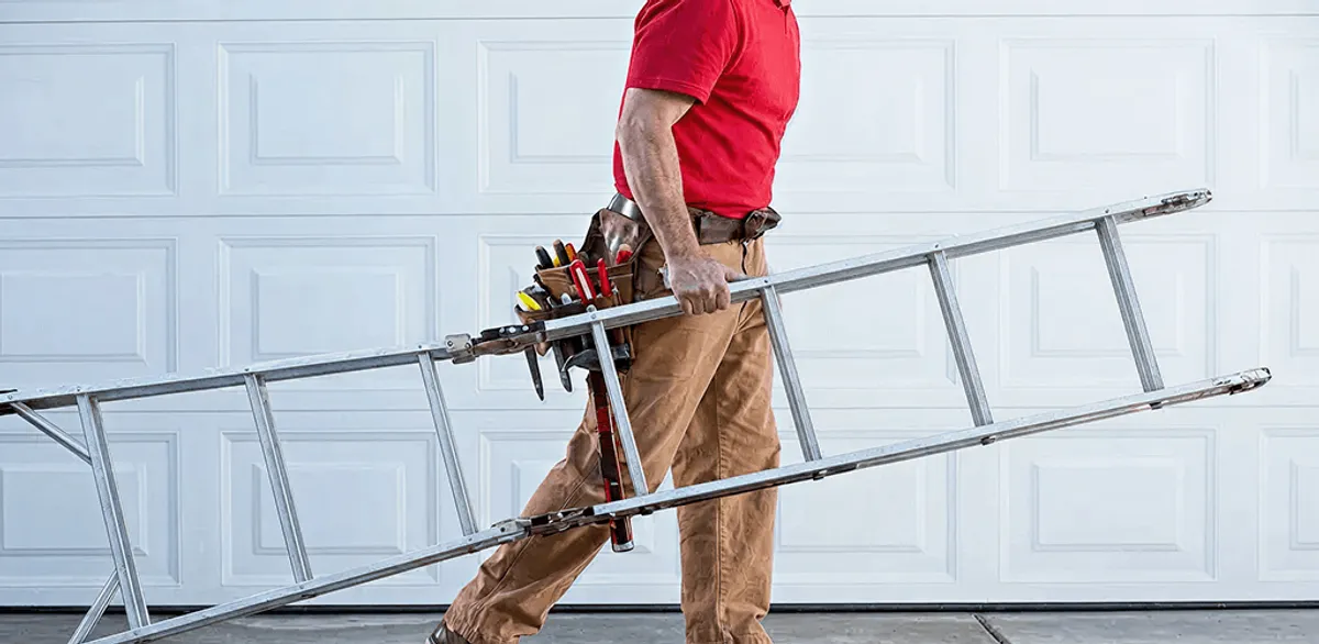 Garage door repair technician arriving with tools and ladder in Atlanta, GA