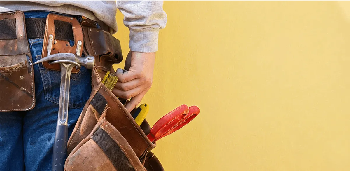Handyman with tool belt ready for home repairs and maintenance in Atlanta, GA