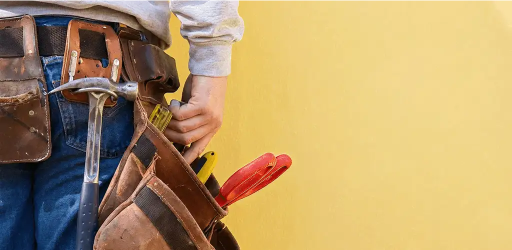 Handyman with tool belt ready for home repairs and maintenance in Atlanta, GA