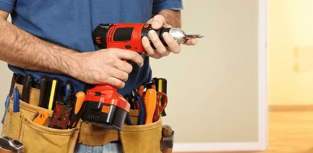 Handyman holding a power drill for home repairs and installations in Atlanta, GA