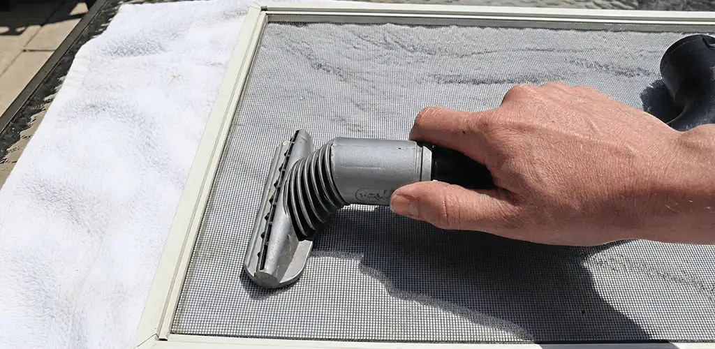 Window screen repair cleaning and fixing a damaged screen mesh in Atlanta, GA